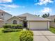 Charming single-story home with a well-manicured lawn and attached two-car garage at 899 Addison Ne Dr, St Petersburg, FL 33716