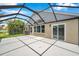 Screened lanai featuring a spacious seating area and picturesque views of the lake at 899 Addison Ne Dr, St Petersburg, FL 33716