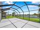 Screened lanai featuring a spacious seating area and picturesque views of the lake at 899 Addison Ne Dr, St Petersburg, FL 33716