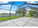 Screened lanai featuring a spacious seating area and picturesque views of the lake at 899 Addison Ne Dr, St Petersburg, FL 33716