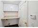 Functional laundry room with built-in cabinets, providing ample storage and convenience at 899 Addison Ne Dr, St Petersburg, FL 33716