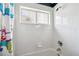 Shower-over-tub with white tile, shower curtain, and window at 899 Addison Ne Dr, St Petersburg, FL 33716