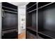 A large walk-in closet with built-in shelving and drawers leads to the bathroom at 899 Addison Ne Dr, St Petersburg, FL 33716
