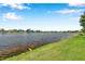 Peaceful waterfront view from grassy lawn offering serene community living under a bright, sunny sky at 899 Addison Ne Dr, St Petersburg, FL 33716