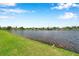 Lovely water view from grassy bank shows tranquil community lifestyle under a bright, sunny sky at 899 Addison Ne Dr, St Petersburg, FL 33716
