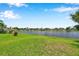 Scenic water view from lush lawn shows tranquil community living under beautiful blue sky at 899 Addison Ne Dr, St Petersburg, FL 33716
