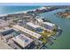 Aerial view showcasing the buildings, pool, beach, and waterfront location at 9755 Harrell Ave # 101, Treasure Island, FL 33706