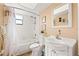 Well-lit bathroom with a shower-tub combo and vanity, providing a functional and pleasant space at 9755 Harrell Ave # 101, Treasure Island, FL 33706