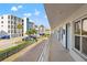 Exterior view of condo building with palm trees, nearby parking and partial view of marina at 9755 Harrell Ave # 101, Treasure Island, FL 33706