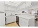 Bright kitchen with white cabinets, updated appliances, and ample counter space, perfect for culinary enthusiasts at 9755 Harrell Ave # 101, Treasure Island, FL 33706