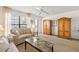 Comfortable living room with plush sofas, marble coffee table, and lots of natural light at 9755 Harrell Ave # 101, Treasure Island, FL 33706