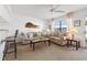 Cozy living room with comfortable seating, coffee table, bar stools and a large picture window at 9755 Harrell Ave # 101, Treasure Island, FL 33706