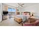 Comfortable main bedroom with a ceiling fan, sliding glass doors to the balcony, and bright decor at 9755 Harrell Ave # 101, Treasure Island, FL 33706