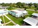 A quiet residential neighborhood showing well-manicured lawns, trees and designated parking spots at 101 Cambridge Trl # 194, Sun City Center, FL 33573