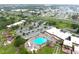 This aerial view showcases the community pool, tennis courts, clubhouse, and green spaces at 101 Cambridge Trl # 194, Sun City Center, FL 33573