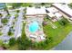 This aerial view showcases the community pool, tennis courts, and plenty of parking at 101 Cambridge Trl # 194, Sun City Center, FL 33573