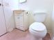 Bathroom features a standard toilet, a sink with cabinet, and tile flooring at 101 Cambridge Trl # 194, Sun City Center, FL 33573