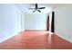 Bedroom featuring wood floors, neutral walls, a ceiling fan, and a closet at 101 Cambridge Trl # 194, Sun City Center, FL 33573