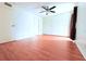 Bedroom features wood floors, white walls, ceiling fan, closet, and one window at 101 Cambridge Trl # 194, Sun City Center, FL 33573