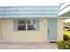 Charming home featuring a light-blue door, matching shutters, and well-maintained landscaping at 101 Cambridge Trl # 194, Sun City Center, FL 33573