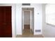 A hallway with tile flooring, closet, and a view to another room at 101 Cambridge Trl # 194, Sun City Center, FL 33573