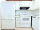 This is a kitchen with a white refrigerator, range, oven, and dishwasher at 101 Cambridge Trl # 194, Sun City Center, FL 33573