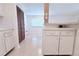 Kitchen area featuring white cabinets and an opening that looks into another room at 101 Cambridge Trl # 194, Sun City Center, FL 33573