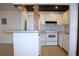 Functional kitchen featuring white cabinetry, essential appliances, and a convenient breakfast bar at 101 Cambridge Trl # 194, Sun City Center, FL 33573