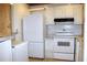 This is a kitchen with white appliances including a refrigerator and oven at 101 Cambridge Trl # 194, Sun City Center, FL 33573