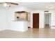 Open-concept living area showcasing tiled floors, a ceiling fan, and a glimpse of the kitchen at 101 Cambridge Trl # 194, Sun City Center, FL 33573