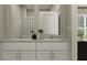 Bathroom with double vanity, granite countertop, modern fixtures, and bright natural light at 10198 Trumpet Honeysuckle Way, San Antonio, FL 33576