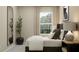 Serene bedroom with a comfortable bed, minimalist decor, and natural light from the window at 10198 Trumpet Honeysuckle Way, San Antonio, FL 33576