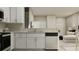 Modern kitchen features white cabinets, stainless steel appliances, and granite countertops at 10198 Trumpet Honeysuckle Way, San Antonio, FL 33576