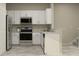 Modern kitchen featuring white cabinets, granite countertops, and stainless steel appliances at 10198 Trumpet Honeysuckle Way, San Antonio, FL 33576