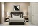 Cozy bedroom features a comfortable bed, stylish lamps, and contemporary artwork at 10198 Trumpet Honeysuckle Way, San Antonio, FL 33576