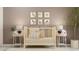 Cozy Bedroom showcases a classic crib, charming animal artwork, and soft lighting, creating a serene space at 10203 Trumpet Honeysuckle Way, San Antonio, FL 33576