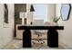 Stylish home office features a contemporary black desk, natural wood cabinet, and modern artwork at 10203 Trumpet Honeysuckle Way, San Antonio, FL 33576