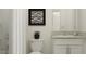Well-lit bathroom featuring a granite vanity top, white cabinets and a shower with a curtain, creating a clean atmosphere at 10211 Trumpet Honeysuckle Way, San Antonio, FL 33576