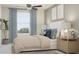 Bright bedroom with a queen bed, bedside tables, lamps and a ceiling fan, creating a peaceful atmosphere at 10211 Trumpet Honeysuckle Way, San Antonio, FL 33576