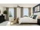 Bright main bedroom with large windows, comfortable seating, and stylish decor creates a cozy atmosphere at 10211 Trumpet Honeysuckle Way, San Antonio, FL 33576
