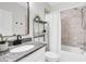 Bathroom with white vanity, granite counters, tub, shower and decorative shelves at 106 Cutlass Way, Oldsmar, FL 34677