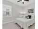 Bedroom with large window, ceiling fan, light carpet and a queen bed at 106 Cutlass Way, Oldsmar, FL 34677