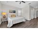 This bedroom offers a ceiling fan, modern floors and a neatly made bed at 106 Cutlass Way, Oldsmar, FL 34677