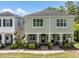Charming exterior of a two-story home featuring a cozy front porch with green doors and neatly landscaped surroundings at 106 Cutlass Way, Oldsmar, FL 34677