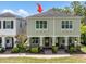 Charming exterior of a two-story home featuring a cozy front porch with green doors and neatly landscaped surroundings at 106 Cutlass Way, Oldsmar, FL 34677