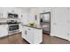 Modern kitchen featuring white cabinets, granite countertops, stainless steel appliances, and a center island at 106 Cutlass Way, Oldsmar, FL 34677