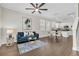 Open-concept living space with dark wood floors, seamlessly connecting the living area to the modern kitchen at 106 Cutlass Way, Oldsmar, FL 34677