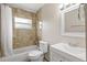 Bright bathroom featuring a tub with tile surround and a vanity at 11029 Clay Pit Rd, Tampa, FL 33610