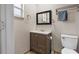 Charming bathroom featuring a vanity with drawers, a toilet, and a mirror at 11029 Clay Pit Rd, Tampa, FL 33610