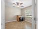 Bedroom featuring tile floors, a ceiling fan, and a desk at 11029 Clay Pit Rd, Tampa, FL 33610